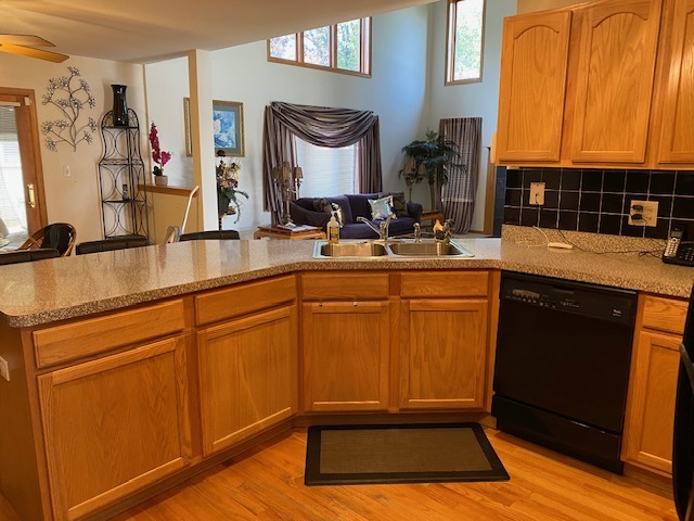 Undisclosed Address Olympia Fields, IL 60461 - Photo 11 of 31 a room with kitchen island granite countertop wooden cabinets a sink and a stove with wooden floor