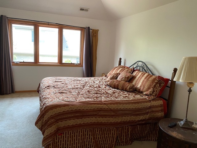 Undisclosed Address Olympia Fields, IL 60461 - Photo 24 of 31 a bedroom with a bed and wooden floor