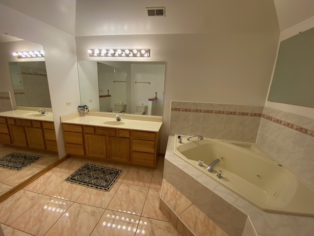 Undisclosed Address Olympia Fields, IL 60461 - Photo 26 of 31 a bathroom with a sink double vanity mirror and a bathtub