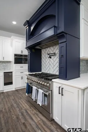 a kitchen with stainless steel appliances granite countertop a stove and a microwave