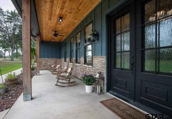 a view of a patio with chairs and potted plants