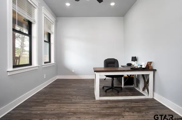 a view of a workspace with furniture window and wooden floor
