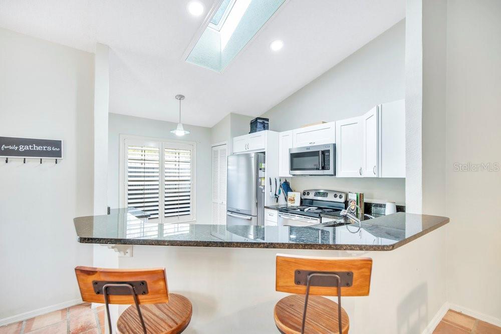 1500 Rivers Edge Drive Orlando, FL 32825 - Photo 8 of 33 a kitchen with stainless steel appliances granite countertop a sink and a white cabinets