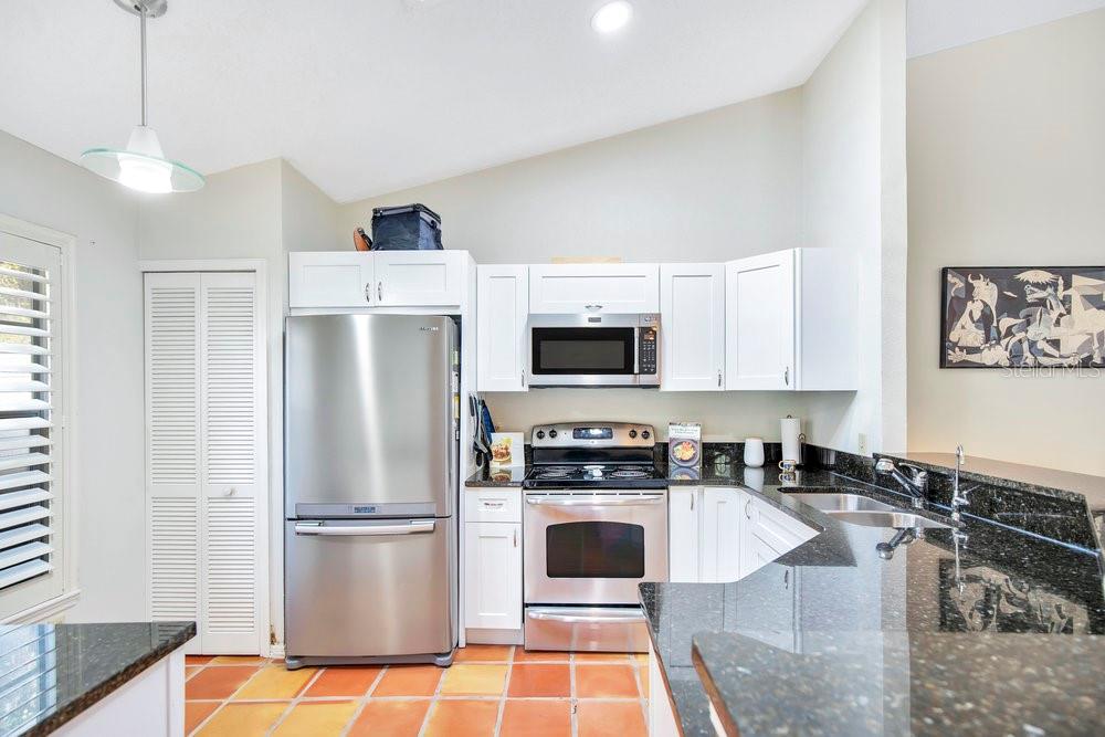 1500 Rivers Edge Drive Orlando, FL 32825 - Photo 9 of 33 a kitchen with stainless steel appliances granite countertop a refrigerator a stove a sink and white cabinets