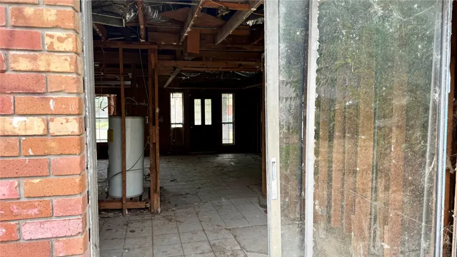 a view of a porch with a table and a chair