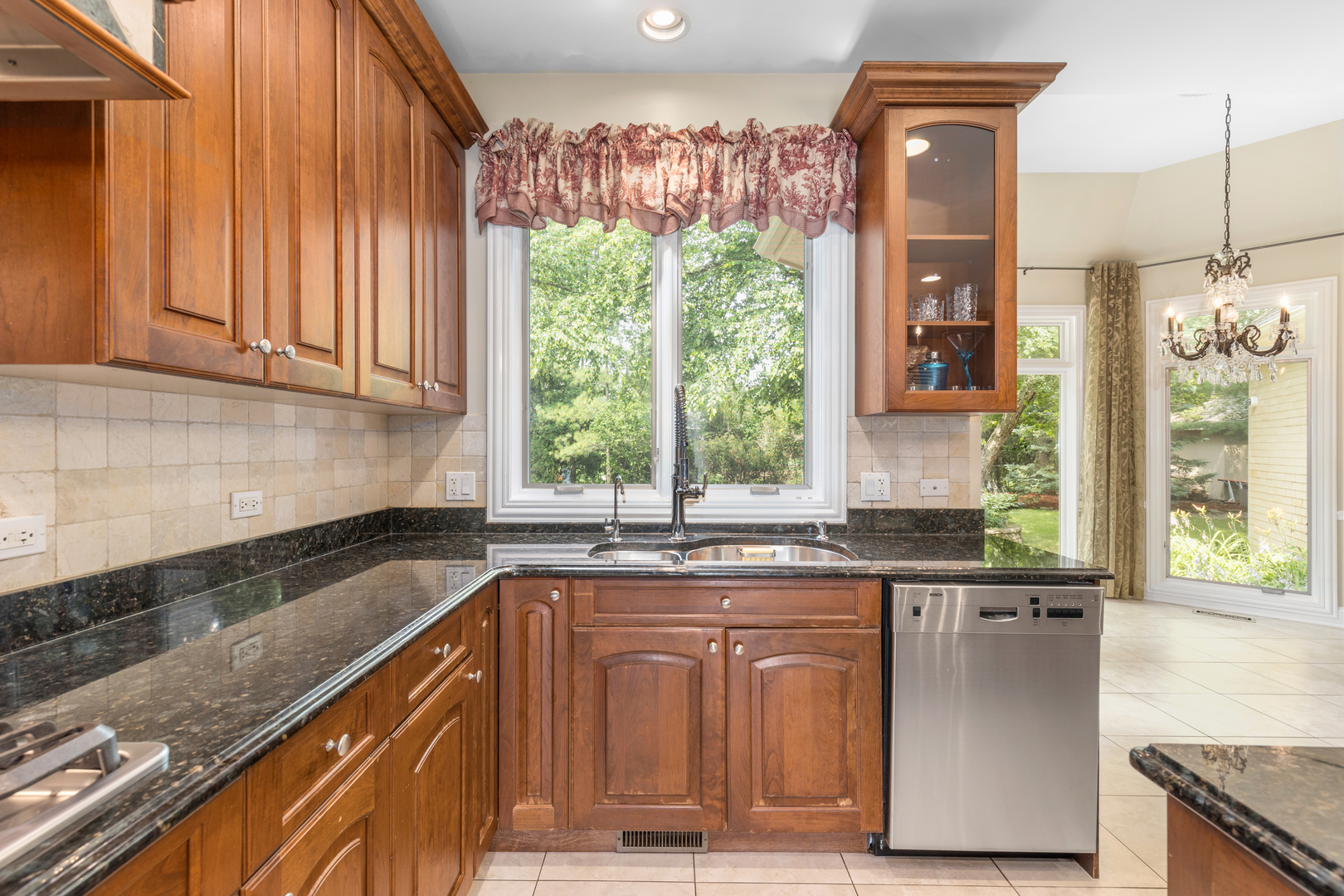 238 Linden Road Northbrook, IL 60062 - Photo 11 of 51 a kitchen with stainless steel appliances granite countertop a sink a stove and a refrigerator