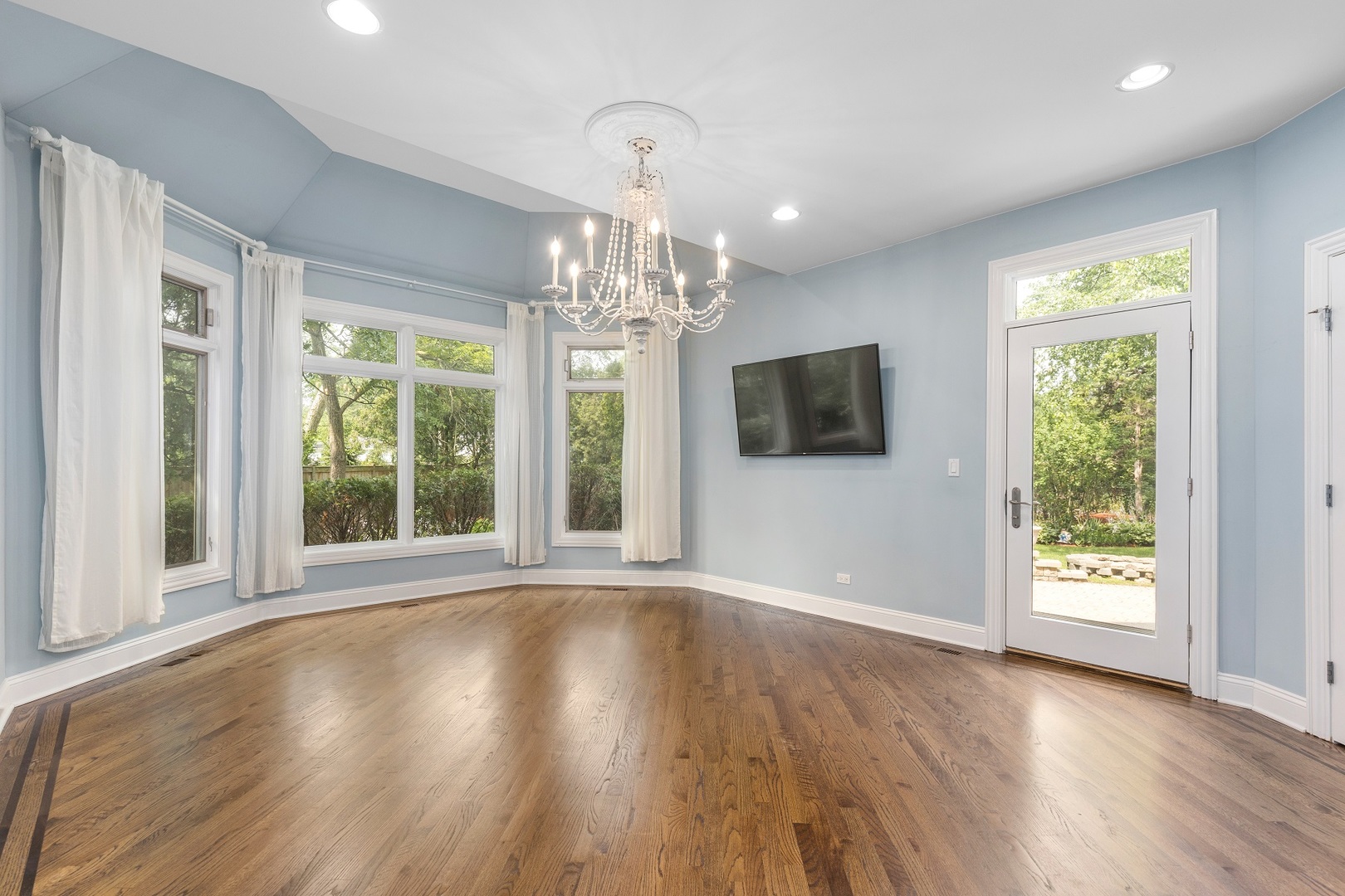 238 Linden Road Northbrook, IL 60062 - Photo 14 of 51 a view of a big room with wooden floor chandelier and windows
