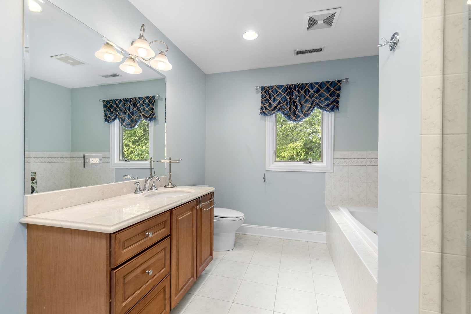 238 Linden Road Northbrook, IL 60062 - Photo 29 of 51 a bathroom with a sink a toilet and a mirror