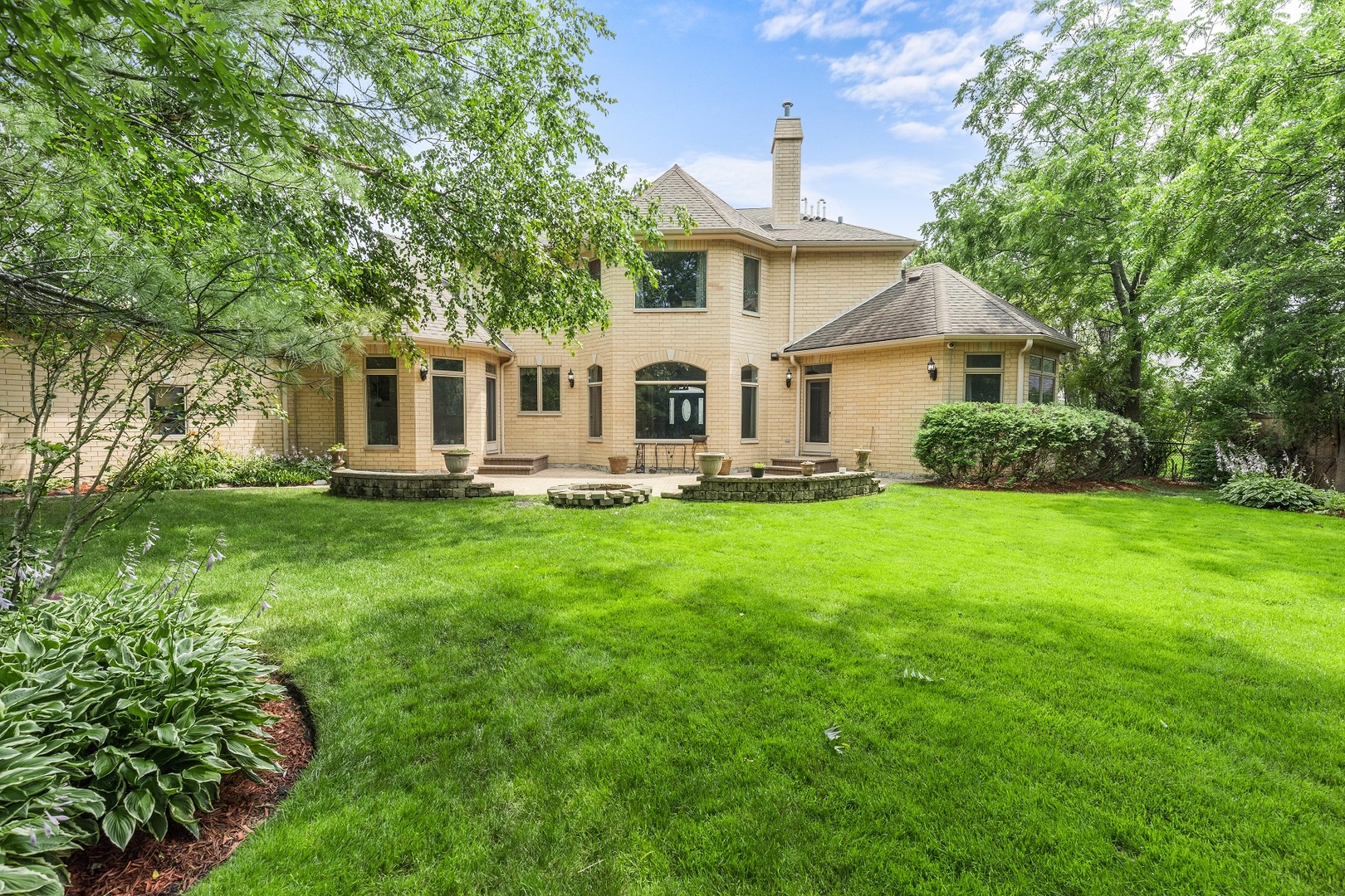 238 Linden Road Northbrook, IL 60062 - Photo 45 of 51 a front view of a house with a yard table and chairs