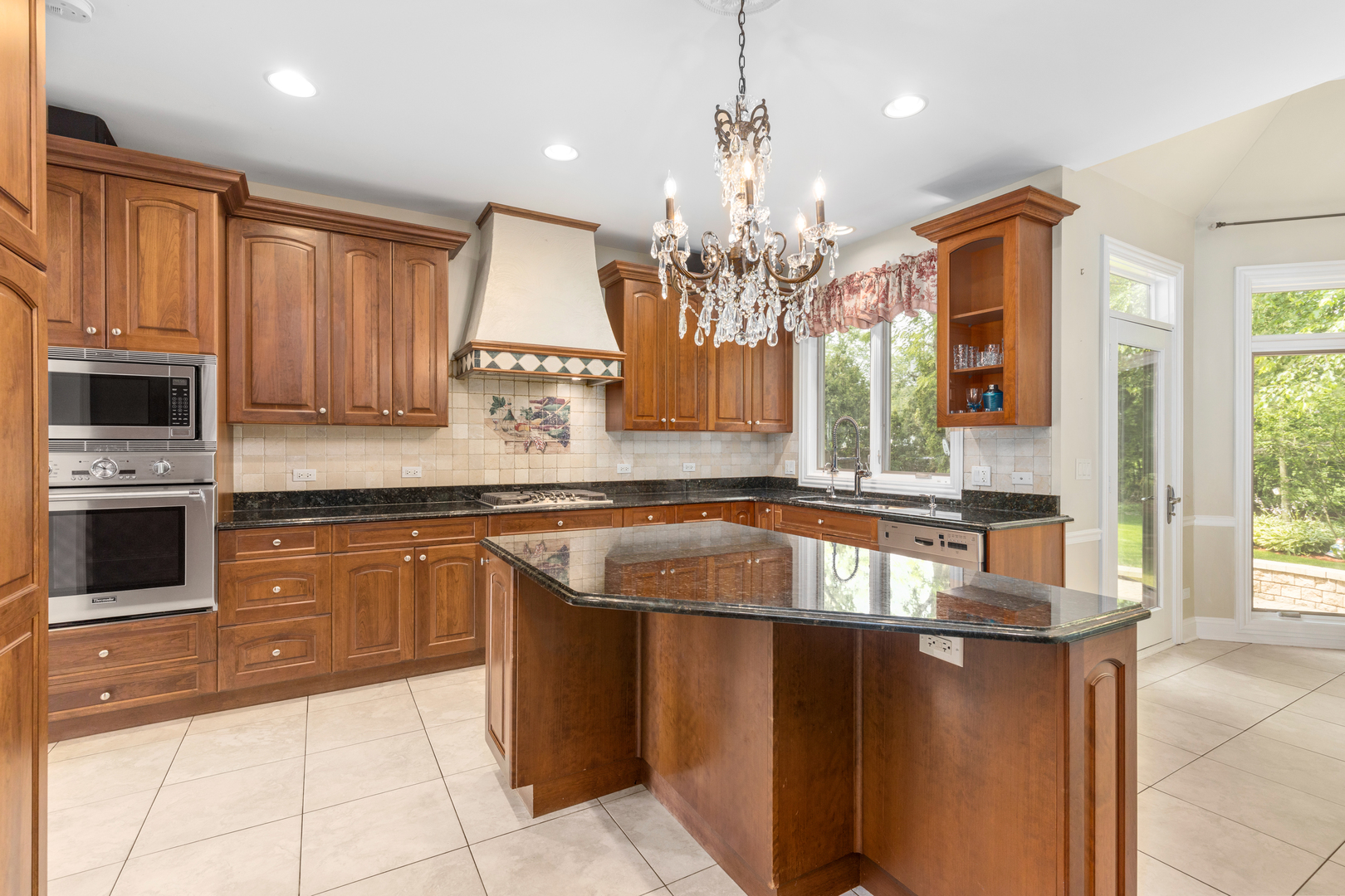 238 Linden Road Northbrook, IL 60062 - Photo 9 of 51 a kitchen with stainless steel appliances granite countertop a sink and a microwave