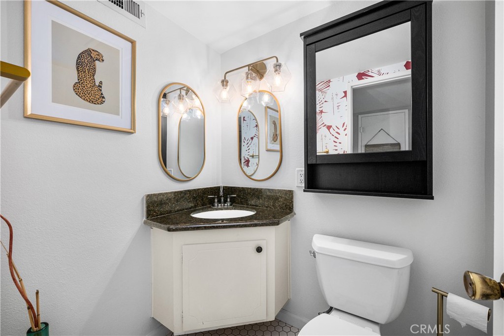 4237 Larwin Avenue Cypress, CA 90630 - Photo 19 of 48 a bathroom with a toilet a sink and mirror