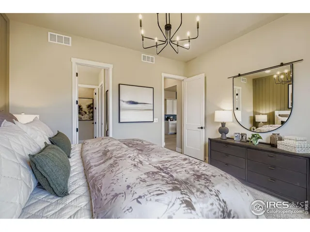 a bedroom with a bed and a chandelier