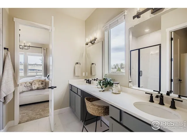 a en suite bathroom with sinks a large mirror and vanity