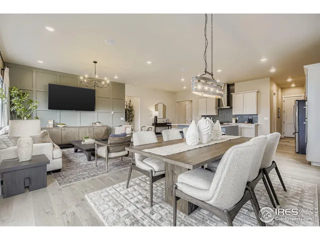 a living room with furniture a dining table and a chandelier
