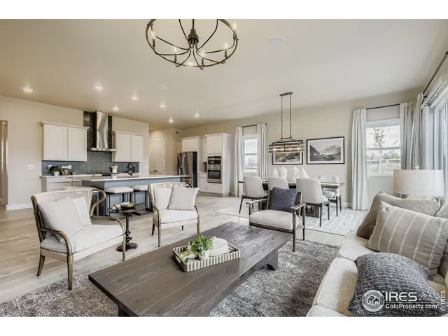 a living room with furniture and kitchen view