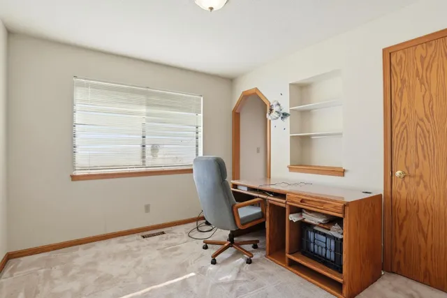 a bedroom with a large bed and a large window