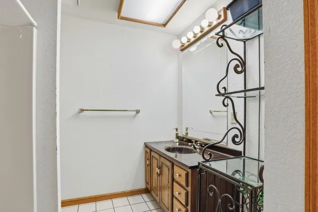 a spacious bedroom with a large bed and a chandelier