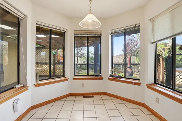 a view of an empty room with fire place and a fireplace