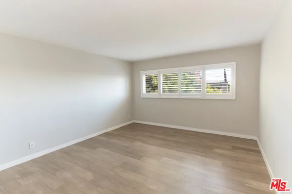 a view of walk in closet and bedroom
