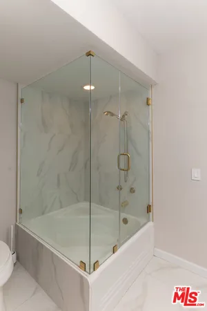 a bathroom with a tub and a shower