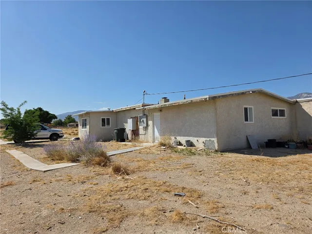 a view of a house with snow in the background