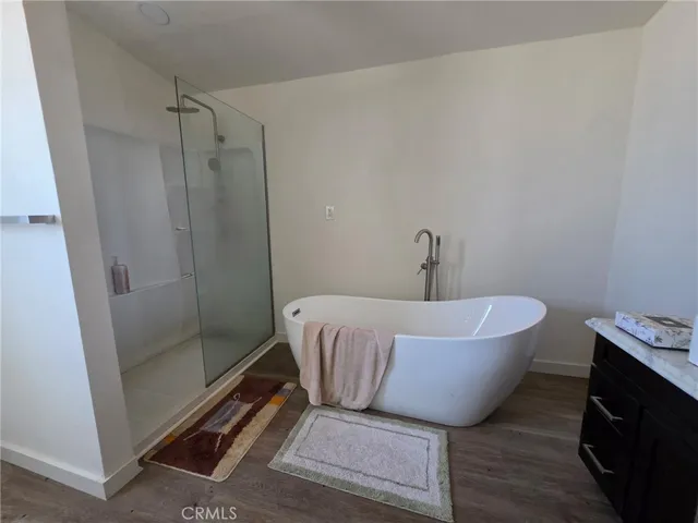 a bathroom with a bathtub and shower