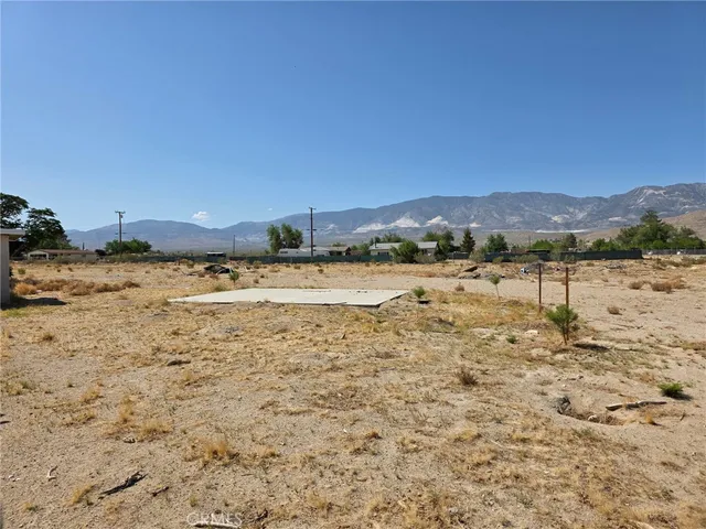a view of a dry yard with mountains