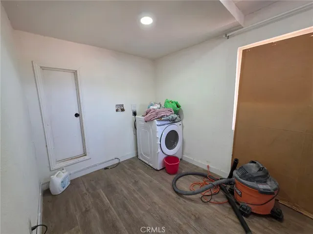 a view of a room with wooden floor and utility room