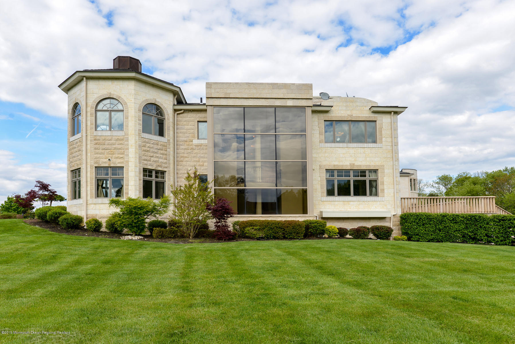 8 Squan Song Lane Colts Neck, NJ 07722 - Photo 11 of 16 a front view of a house with a garden and plants