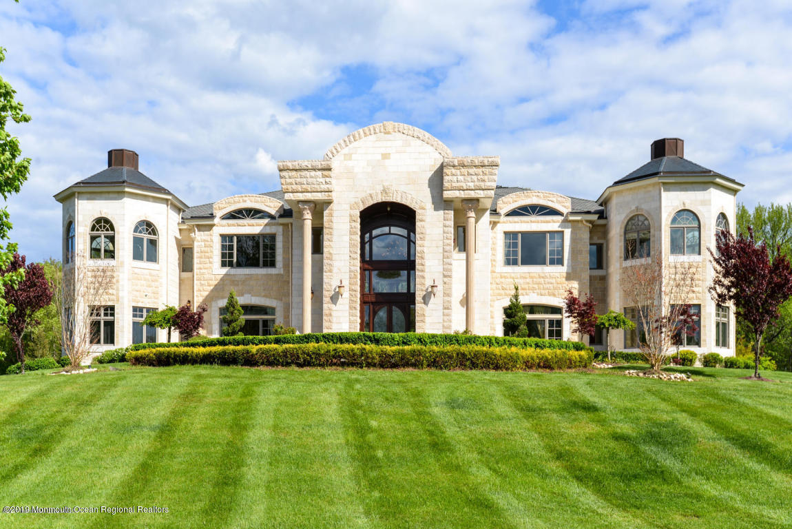 8 Squan Song Lane Colts Neck, NJ 07722 - Photo 4 of 16 a front view of a house with a yard