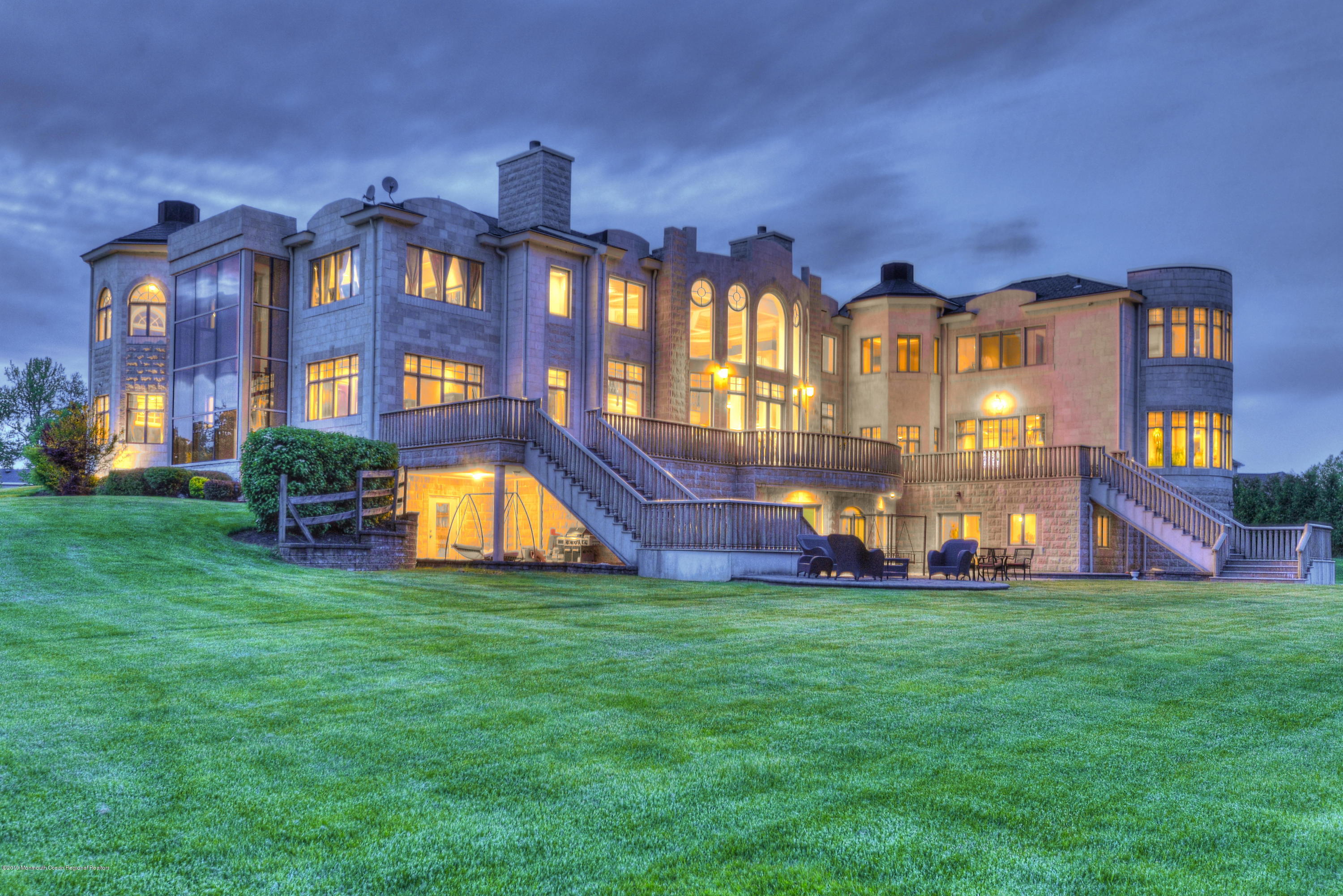 8 Squan Song Lane Colts Neck, NJ 07722 - Photo 5 of 16 a view of a big building with big yard and large trees