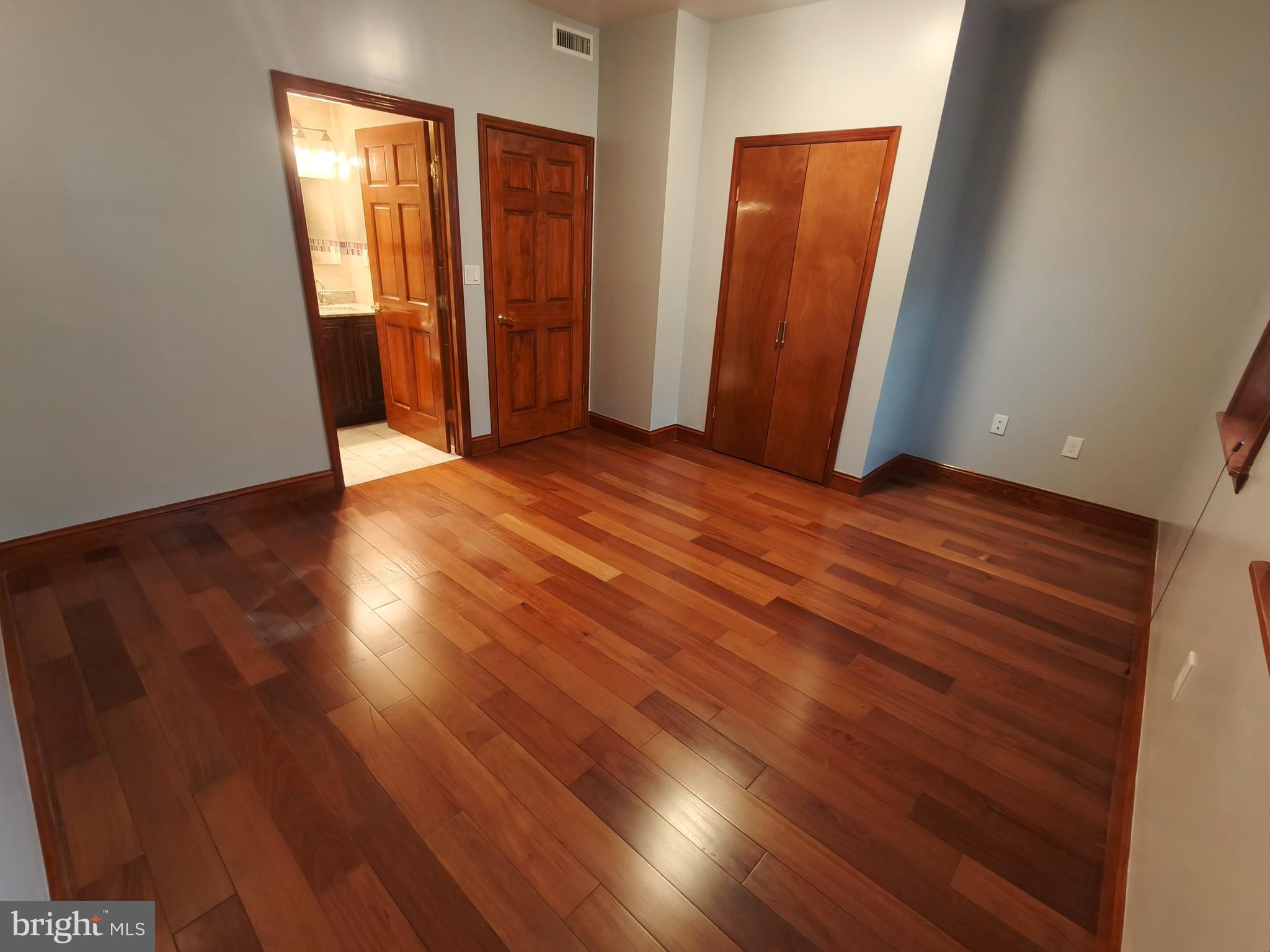 1106 Wallace Street, Unit B Philadelphia, PA 19123 - Photo 11 of 28 an empty room with wooden floor and closet