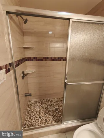 a bathroom with a shower and a sink