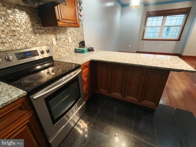 a kitchen with granite countertop a stove and a sink