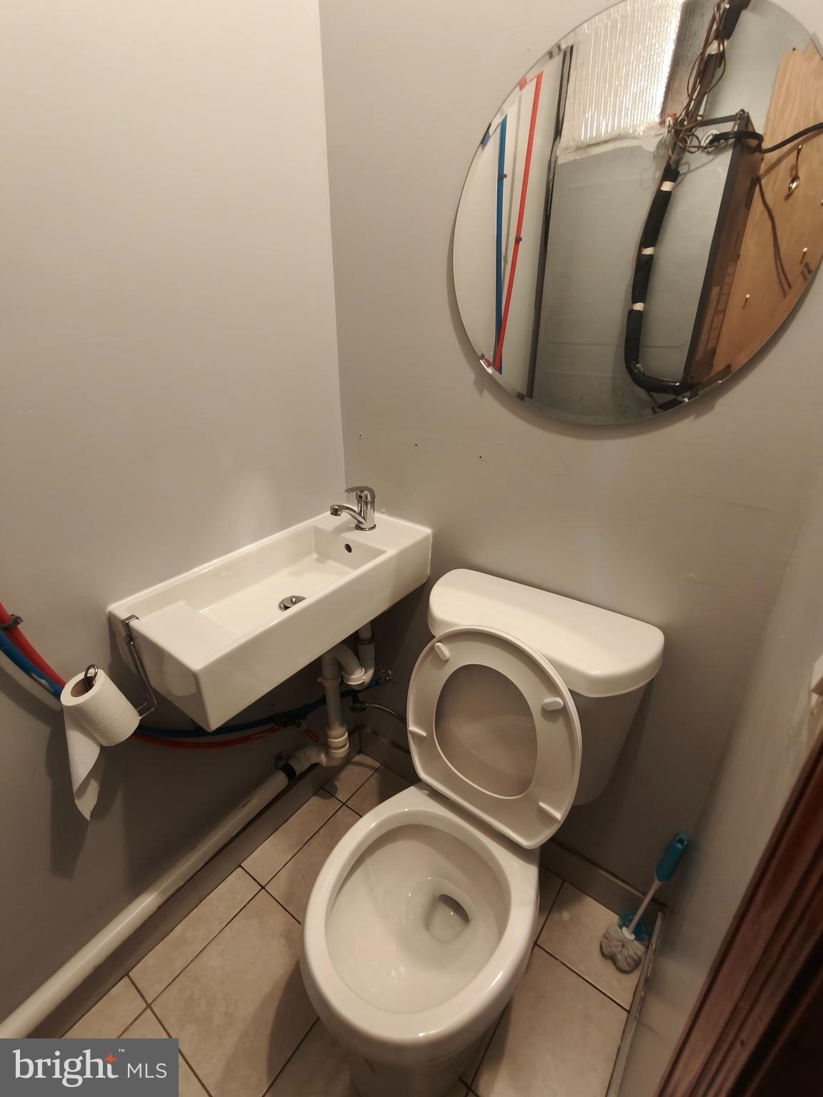 1106 Wallace Street, Unit B Philadelphia, PA 19123 - Photo 8 of 28 a bathroom with a toilet mirror and a sink