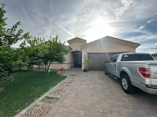 6830 North 14th Street Phoenix, AZ 85014 - Photo 27 of 28 a front view of a house with a garden and parking space