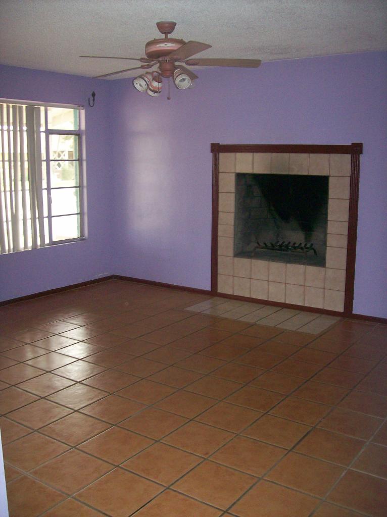 3715 West Lamar Road Phoenix, AZ 85019 - Photo 2 of 9 a view of empty room with window and fireplace