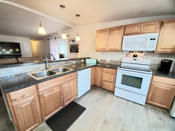 a kitchen with stainless steel appliances granite countertop a sink and cabinets