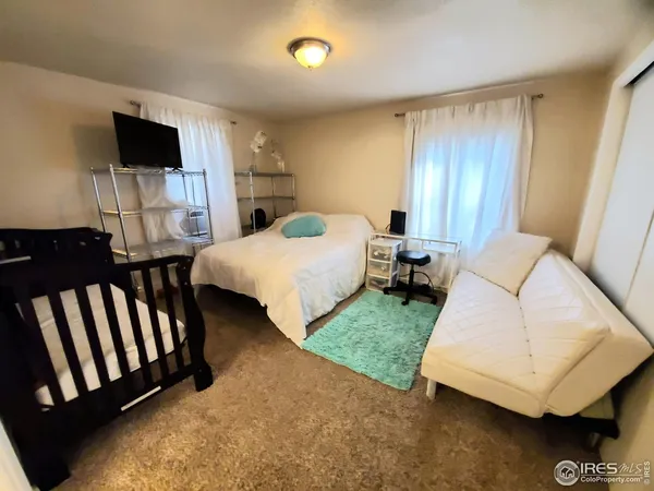 a bedroom with two beds and a flat screen tv
