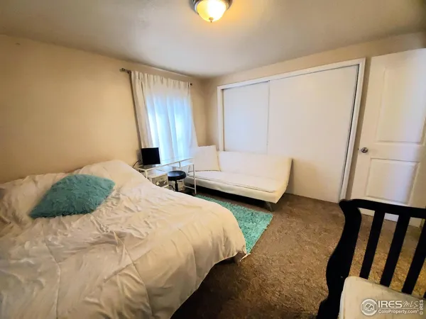 a bedroom with two beds and a chandelier