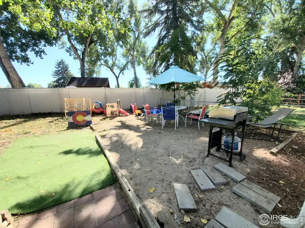 a view of a backyard with sitting area