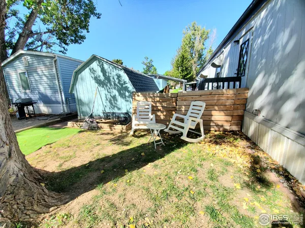 a view of a backyard with sitting area
