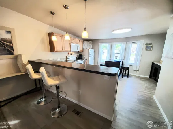 a dining room with furniture and wooden floor