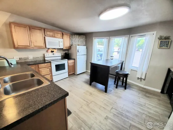 a kitchen with granite countertop sink cabinets and dining table