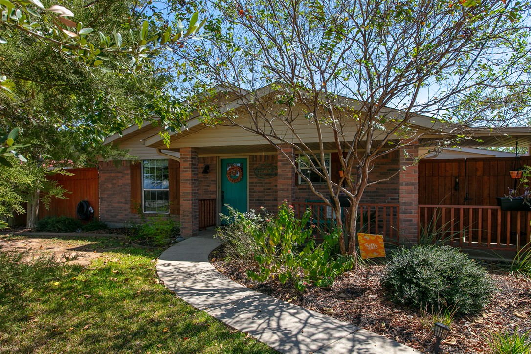 View of front of house with brick siding