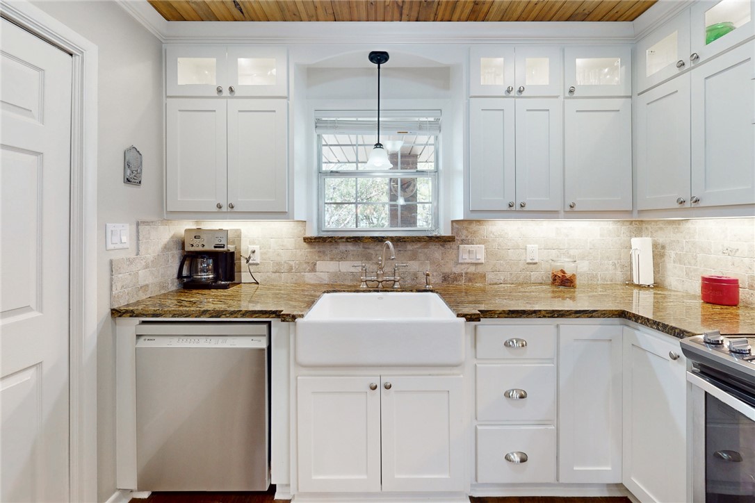 3710 Mancuso Road Bryan, TX 77808 - Photo 11 of 42 Kitchen featuring glass insert cabinets, stainless steel appliances, pendant lighting, white cabinets, and wood ceiling