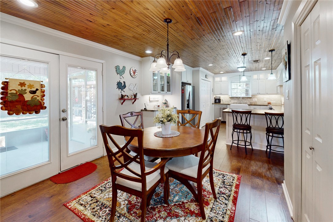 3710 Mancuso Road Bryan, TX 77808 - Photo 14 of 42 Dining space with ornamental molding, recessed lighting, dark wood-style flooring, wooden ceiling, and a chandelier
