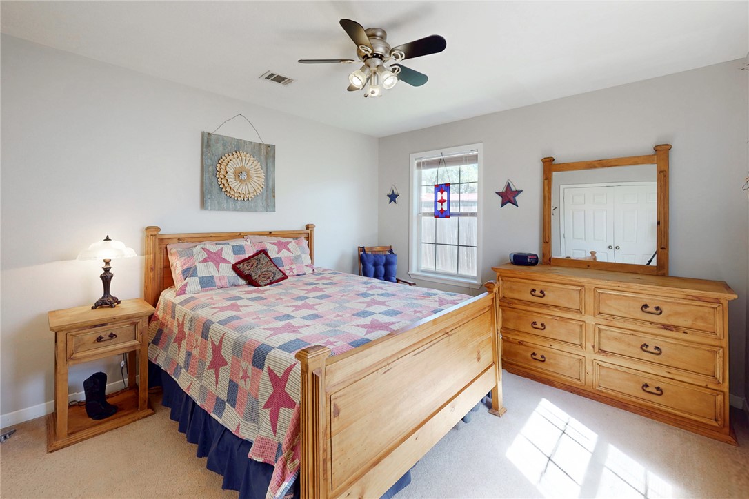 3710 Mancuso Road Bryan, TX 77808 - Photo 27 of 42 Bedroom with light colored carpet and a ceiling fan