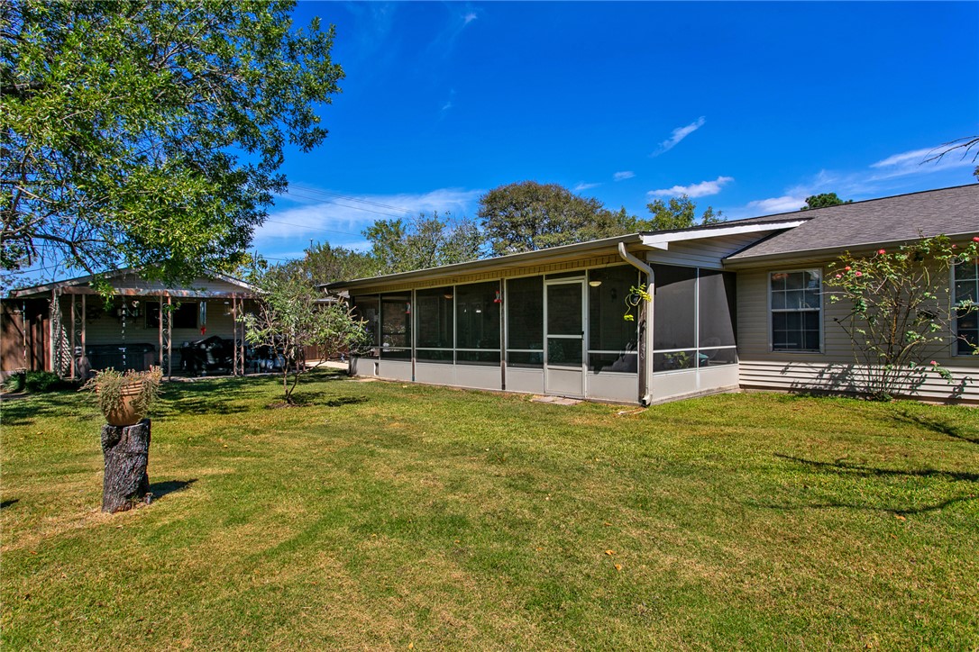 3710 Mancuso Road Bryan, TX 77808 - Photo 30 of 42 Rear view of property with a lawn and a sunroom