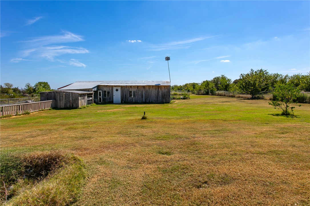 3710 Mancuso Road Bryan, TX 77808 - Photo 35 of 42 View of green lawn featuring an outdoor structure and a pole building
